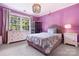 Cozy bedroom featuring panel molding, a window with a view, and a stylish chandelier at 19946 River Falls Dr, Davidson, NC 28036