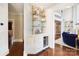 This butler's pantry has glass shelves, white cabinetry, and a beverage refrigerator at 19946 River Falls Dr, Davidson, NC 28036