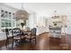 Open floor plan dining area with a round dining table, large windows, and a modern chandelier at 19946 River Falls Dr, Davidson, NC 28036
