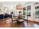 Bright dining area features a round table, modern chandelier, and large windows with lots of natural light at 19946 River Falls Dr, Davidson, NC 28036