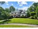 Charming two-story white home with black shutters, a well-manicured lawn, and mature trees enhancing curb appeal at 19946 River Falls Dr, Davidson, NC 28036