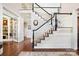 Elegant foyer showcasing a staircase with dark wood and white railings and hardwood flooring at 19946 River Falls Dr, Davidson, NC 28036