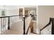 Elegant hallway featuring a curved balcony, built-in bookshelves, and sophisticated architectural details at 19946 River Falls Dr, Davidson, NC 28036