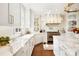 This gourmet kitchen has a large window, modern appliances, and white cabinetry at 19946 River Falls Dr, Davidson, NC 28036