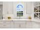 This kitchen has white cabinets, marble countertops, modern fixtures, and stainless steel appliances at 19946 River Falls Dr, Davidson, NC 28036