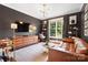 Comfortable living room features modern lighting, a brown leather couch, and a decorative area rug at 19946 River Falls Dr, Davidson, NC 28036