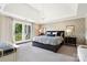Luxurious main bedroom with a private balcony, trey ceilings, and designer wallpaper at 19946 River Falls Dr, Davidson, NC 28036