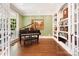 Bright home office features a piano, built-in bookshelves, and a large window providing natural light at 19946 River Falls Dr, Davidson, NC 28036