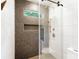Newly remodeled shower featuring sleek fixtures, a glass door, and stylish tile work at 19946 River Falls Dr, Davidson, NC 28036