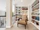 Cozy sitting area features custom built-in bookshelves and a comfortable accent chair at 19946 River Falls Dr, Davidson, NC 28036