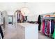 Spacious walk-in closet featuring custom shelving, a center island, and ample storage space at 19946 River Falls Dr, Davidson, NC 28036
