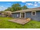 Exterior view of backyard features a deck and lush green lawn at 211 Ridgecrest St, Kannapolis, NC 28081