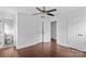 Spacious bedroom with hardwood floors, ceiling fan, and multiple closet doors for ample storage at 211 Ridgecrest St, Kannapolis, NC 28081