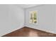 Bright bedroom features wood floors and a window providing natural light at 211 Ridgecrest St, Kannapolis, NC 28081