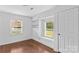 Bright bedroom with built-in shelving and bench, featuring hardwood floors and natural light at 211 Ridgecrest St, Kannapolis, NC 28081
