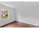 Sunny bedroom with hardwood floors and a large window that allows lots of natural light at 211 Ridgecrest St, Kannapolis, NC 28081