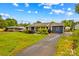 Charming single-story home with a well-manicured front yard and long driveway at 211 Ridgecrest St, Kannapolis, NC 28081