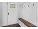 Bright foyer features coat hooks, shelving, and a bench next to the front door at 211 Ridgecrest St, Kannapolis, NC 28081