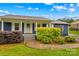Inviting front porch featuring classic columns, a white door and lush landscaping at 211 Ridgecrest St, Kannapolis, NC 28081