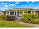 Cozy front porch featuring classic columns, a white door and lush landscaping at 211 Ridgecrest St, Kannapolis, NC 28081