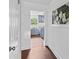 Hallway view into a kitchen with blue cabinets, stainless steel appliances, and tile backsplash at 211 Ridgecrest St, Kannapolis, NC 28081
