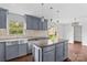 Bright kitchen with stainless steel appliances, granite countertops, island, and a view to the backyard at 211 Ridgecrest St, Kannapolis, NC 28081