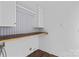 Well-lit laundry room with overhead cabinets, ample counter space, and patterned accent wall at 211 Ridgecrest St, Kannapolis, NC 28081