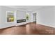 Cozy living room with fireplace, large windows, and hardwood floors at 211 Ridgecrest St, Kannapolis, NC 28081