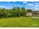 An exterior shot of a large backyard with a shed, trees, and green grass at 211 Ridgecrest St, Kannapolis, NC 28081