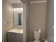 Updated bathroom with vanity, modern lighting, toilet, and framed mirror at 2958 Iron Gate Ln, Charlotte, NC 28212