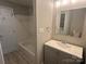 Bathroom with a shower/tub combo and sleek vanity with updated fixtures at 2958 Iron Gate Ln, Charlotte, NC 28212