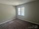 Neutral bedroom with window allowing natural light and soft carpeted flooring at 2958 Iron Gate Ln, Charlotte, NC 28212