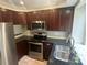 Kitchen featuring stainless steel appliances, dark counters, and beautiful wood cabinets at 2958 Iron Gate Ln, Charlotte, NC 28212