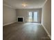 Spacious living room featuring a cozy fireplace and sliding glass doors to the backyard at 2958 Iron Gate Ln, Charlotte, NC 28212