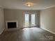 Bright living room showcasing a fireplace and doors that lead to a patio area at 2958 Iron Gate Ln, Charlotte, NC 28212