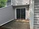 A concrete patio featuring access to the house through black glass doors at 2958 Iron Gate Ln, Charlotte, NC 28212