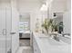 Bright bathroom featuring double sinks, quartz counters, and a view to an adjacent bedroom at 3748 Ellington St, Charlotte, NC 28211