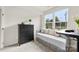 Bright bedroom with a daybed, dresser, and large window offering natural light and a view at 3748 Ellington St, Charlotte, NC 28211
