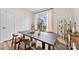 Dining area featuring a modern table, six chairs, large window, and stylish accents at 3748 Ellington St, Charlotte, NC 28211