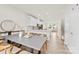 Bright dining room with a sleek table adjacent to an open-concept kitchen featuring a breakfast bar at 3748 Ellington St, Charlotte, NC 28211