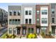 Modern townhome exteriors with brick and siding details, complemented by green shrubs and manicured landscaping at 3748 Ellington St, Charlotte, NC 28211