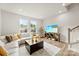 Cozy living room area with a sectional sofa, modern entertainment center, and large windows at 3748 Ellington St, Charlotte, NC 28211
