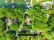 Aerial view of a wooded lot with a home, showcasing privacy and lush surroundings near a tranquil lake at 4120 Lake Shore S Rd, Denver, NC 28037