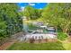 Lakefront backyard featuring a sandy beach, private dock, and lush greenery, creating a serene outdoor oasis at 4120 Lake Shore S Rd, Denver, NC 28037