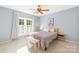 Bright bedroom with a window, a ceiling fan, and neutral decor at 4120 Lake Shore S Rd, Denver, NC 28037
