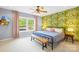 Charming bedroom featuring a cozy bed, tropical wallpaper, and a window with a view at 4120 Lake Shore S Rd, Denver, NC 28037