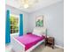 Cozy bedroom featuring a colorful fuchsia bedspread and a bright window with curtains at 4120 Lake Shore S Rd, Denver, NC 28037