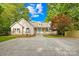 Charming home with a covered porch, manicured lawn, circular driveway and mature trees at 4120 Lake Shore S Rd, Denver, NC 28037