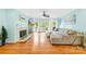 Living room with fireplace, hardwood floors, ceiling fan, and access to the outdoor deck at 4120 Lake Shore S Rd, Denver, NC 28037