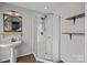 Modern bathroom with glass-enclosed shower, decorative mirror, and open shelving at 415 W 7Th St # H, Charlotte, NC 28202